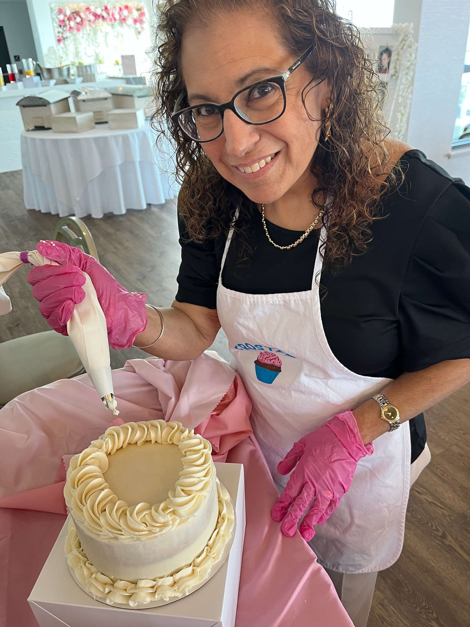 Baker decorating cupcakes by hand