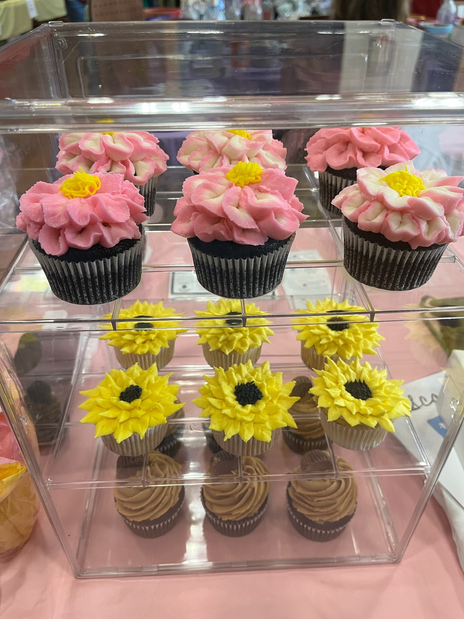 Colorful decorated cupcakes on bakery display